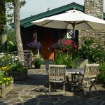 Stone patio and outdoor living room by landscapers in Linville, NC